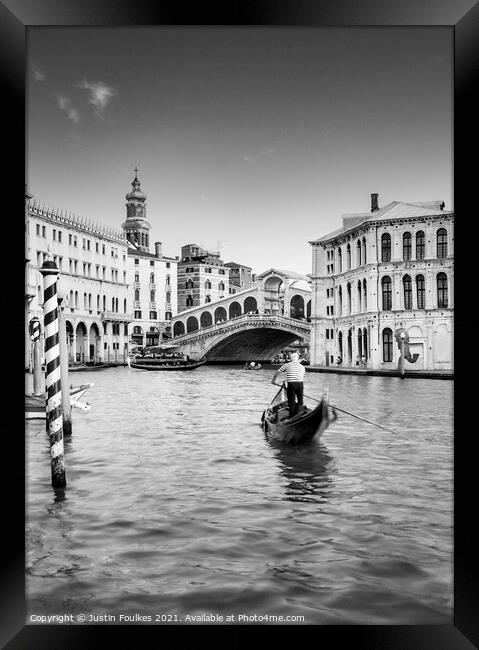 Gondolier at the Rialto bridge, Grand Canal, Venic Framed Print by Justin Foulkes