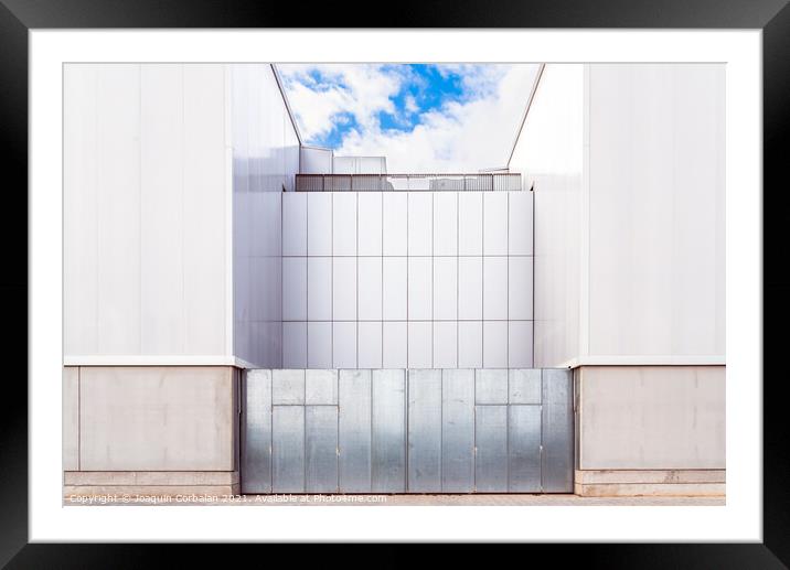 Facade of a door of an industrial warehouse made of gleaming alu Framed Mounted Print by Joaquin Corbalan