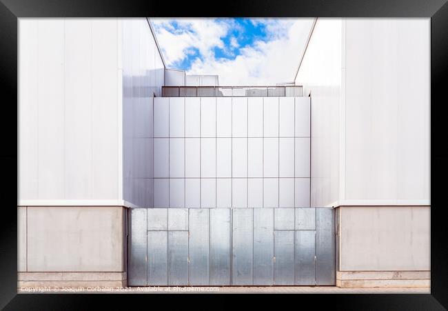 Facade of a door of an industrial warehouse made of gleaming alu Framed Print by Joaquin Corbalan