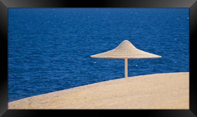 Beach sand sea and parasol Egypt Framed Print by mark humpage