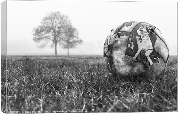deserted football on field Canvas Print by Sara Melhuish