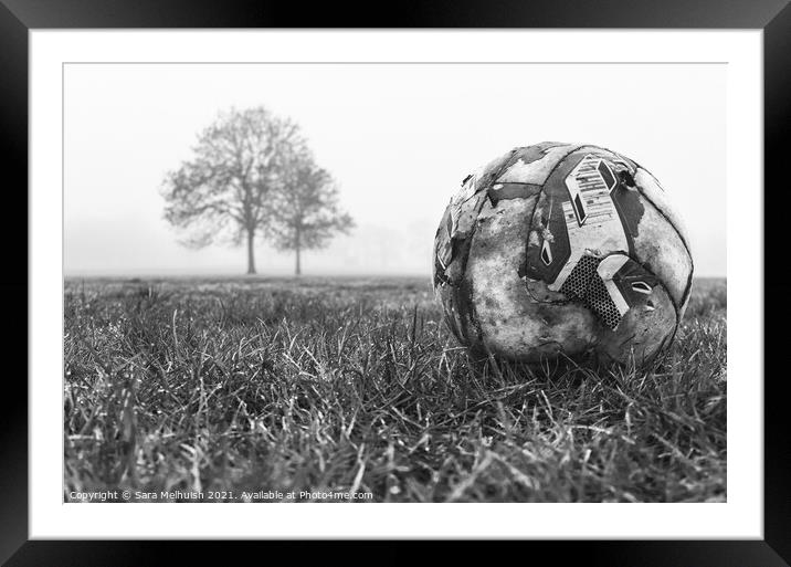deserted football on field Framed Mounted Print by Sara Melhuish