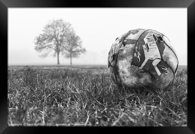 deserted football on field Framed Print by Sara Melhuish