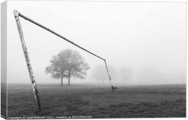 Goal posts and tree in a foggy London park Canvas Print by Sara Melhuish