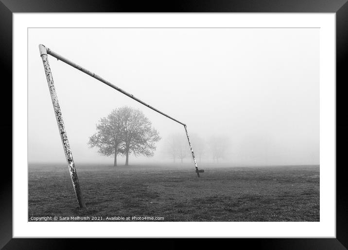 Goal posts and tree in a foggy London park Framed Mounted Print by Sara Melhuish