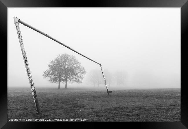 Goal posts and tree in a foggy London park Framed Print by Sara Melhuish