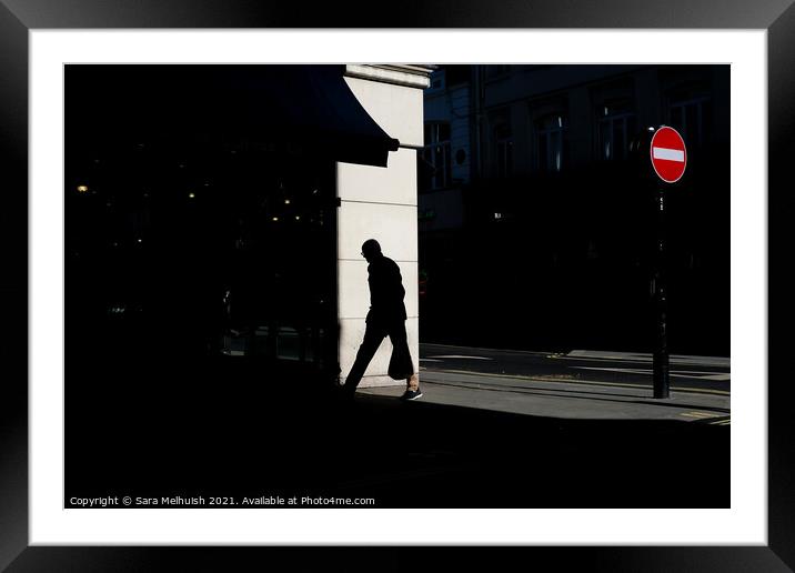 Man on the street in the sunshine Framed Mounted Print by Sara Melhuish