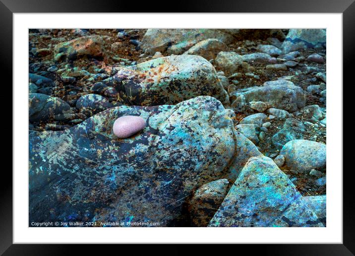 The rocky foreshore of a beach with a single ink pebble Framed Mounted Print by Joy Walker
