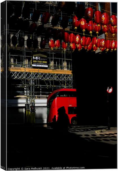 Red bus and lanterns Canvas Print by Sara Melhuish