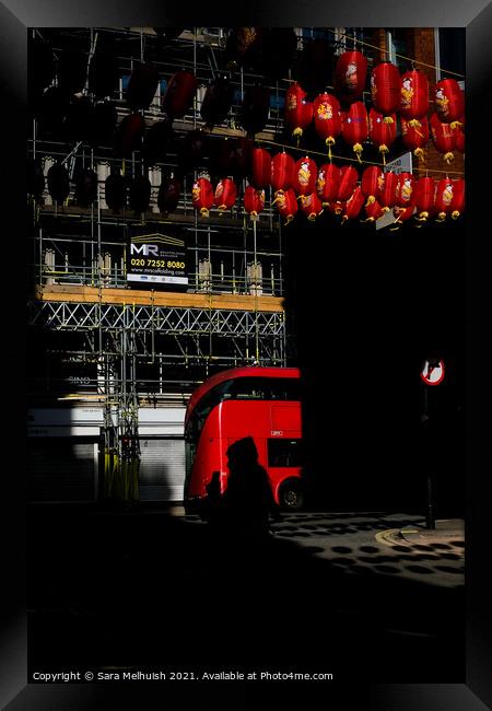 Red bus and lanterns Framed Print by Sara Melhuish