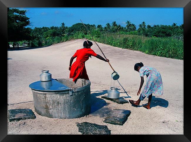 filling water Framed Print by Hassan Najmy