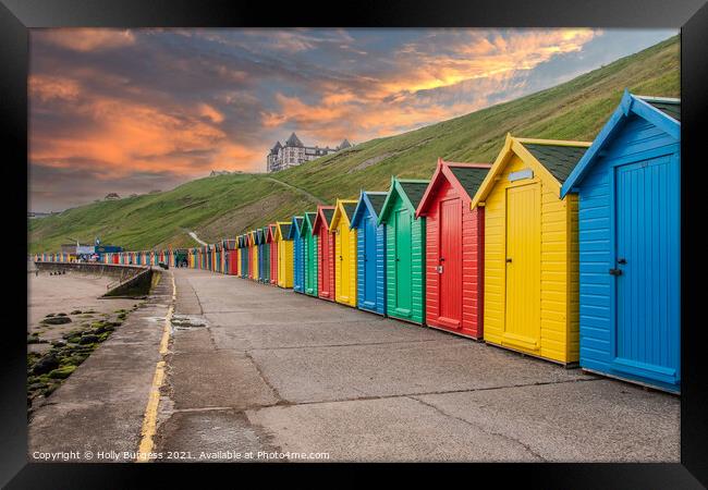 Whitby's Colourful Beach Huts at Sunset Framed Print by Holly Burgess