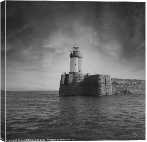Guernsey Lighthouse from the sea in black and whit Canvas Print by Ann Biddlecombe