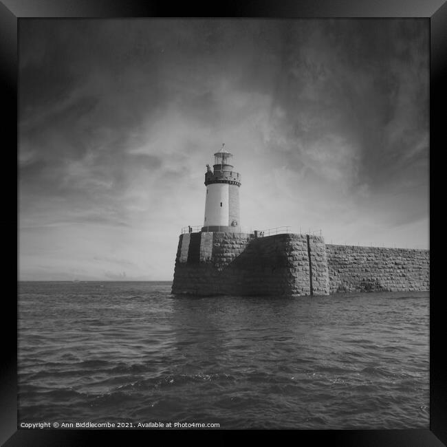 Guernsey Lighthouse from the sea in black and whit Framed Print by Ann Biddlecombe