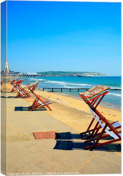 Early morning deckchairs. Canvas Print by john hill