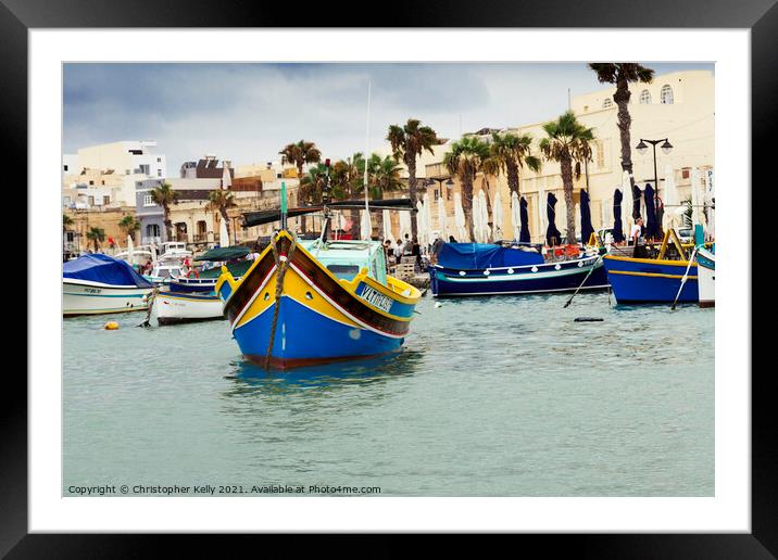 Moored boats in Marsaxlokk Bay  Framed Mounted Print by Christopher Kelly
