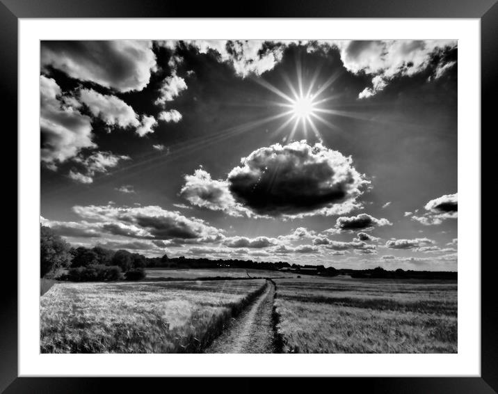 Sun bursting through clouds, black and white. Framed Mounted Print by mark humpage