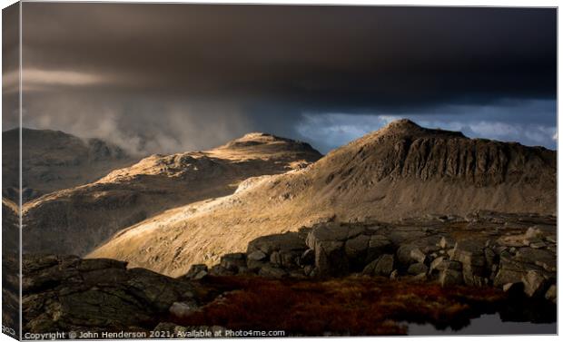 Approaching weather on Bowfell Canvas Print by John Henderson