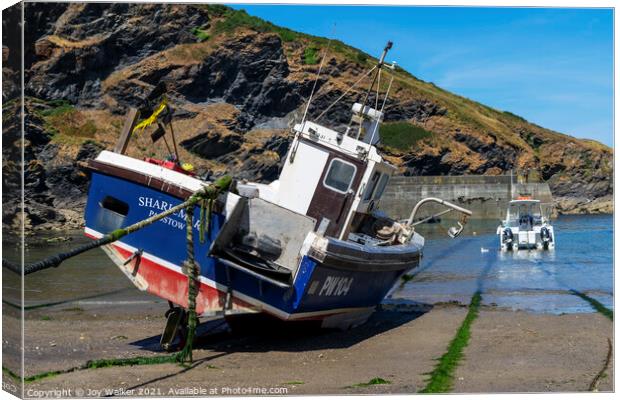 A fishing boat anchored in Port Isaac bay Canvas Print by Joy Walker