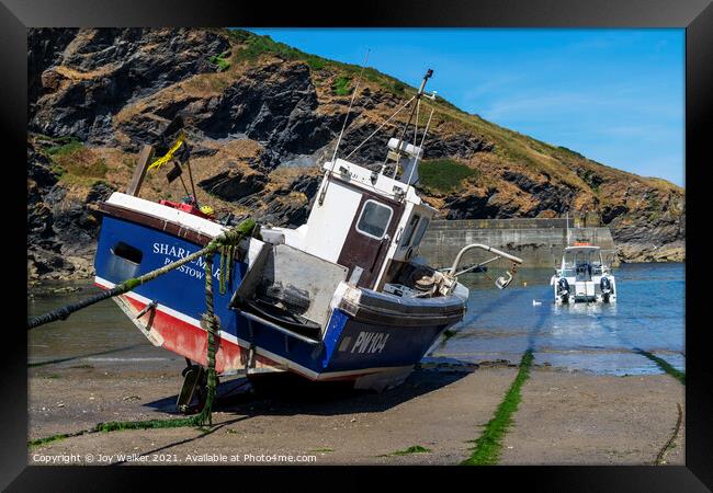 A fishing boat anchored in Port Isaac bay Framed Print by Joy Walker