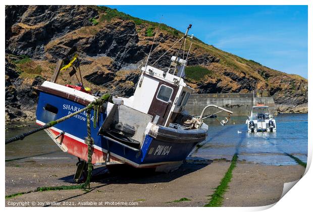 A fishing boat anchored in Port Isaac bay Print by Joy Walker