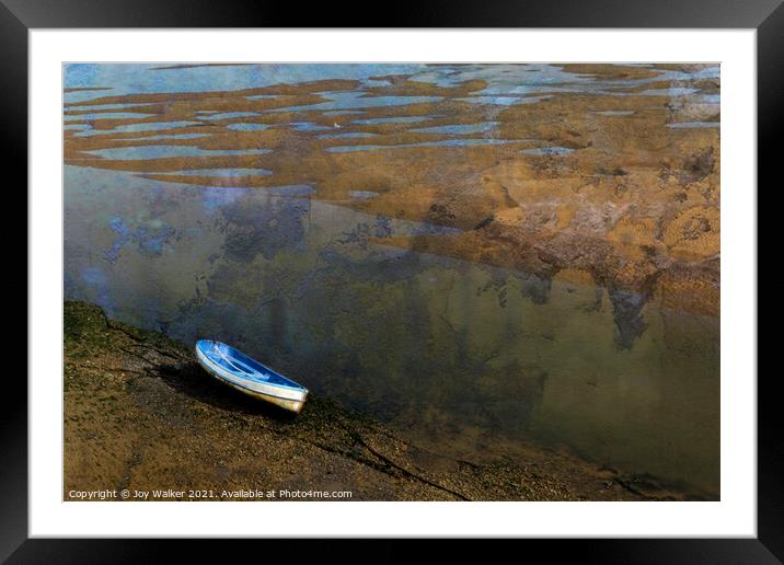 A beached boat anchored while the tide is out Framed Mounted Print by Joy Walker
