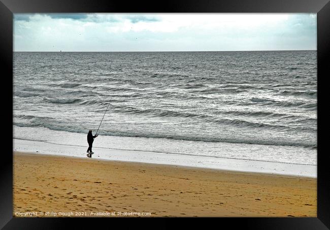 Fishing on the coast Framed Print by Philip Gough
