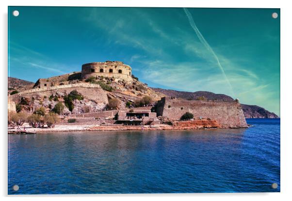 Crete, Greece: Wide angle view of Spinalonga unhabited island with a 16th century venetian fortress and the ruins of a formar leper colony against cloudy blue sky and blue water in the foreground Acrylic by Arpan Bhatia