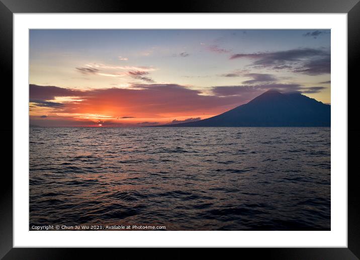 Sunset on the sea with a volcano in Indonesia Framed Mounted Print by Chun Ju Wu