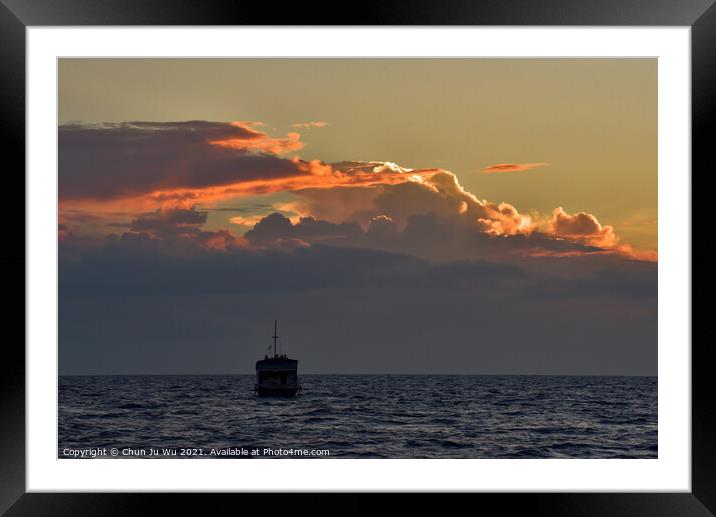 A boat on the sea with sunset light on clouds Framed Mounted Print by Chun Ju Wu