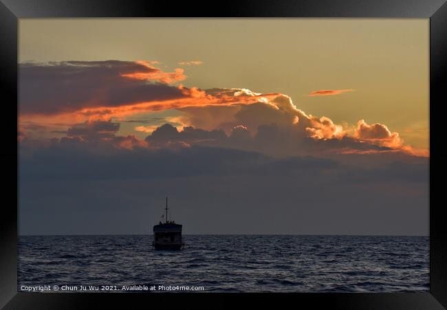A boat on the sea with sunset light on clouds Framed Print by Chun Ju Wu