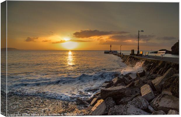 Sunrise over the sea at Looe's Banjo Pier and beach Canvas Print by Jim Peters