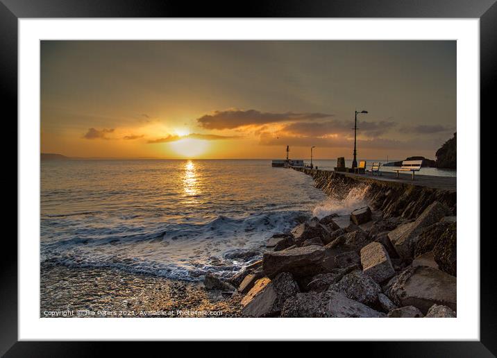 Sunrise over the sea at Looe's Banjo Pier and beach Framed Mounted Print by Jim Peters