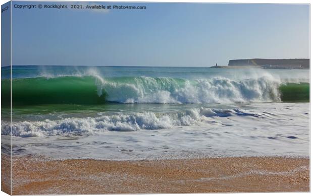 Waves crashing onto a sandy beach in the algarve Canvas Print by Rocklights 