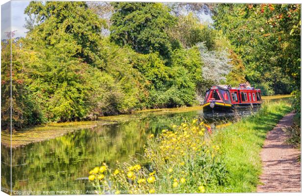 A narrowboat makes its way along the Grand Union canal  Canvas Print by Kevin Hellon