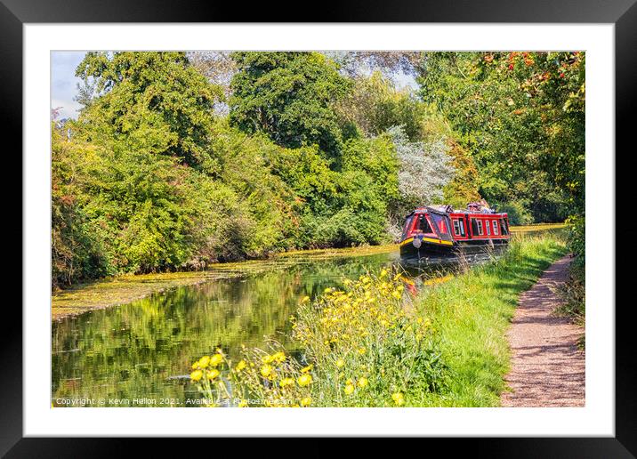 A narrowboat makes its way along the Grand Union canal  Framed Mounted Print by Kevin Hellon