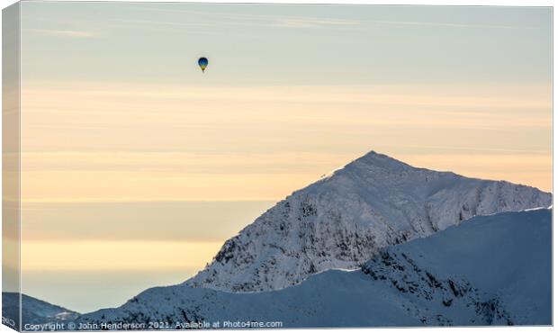 Majestic Hot Air Balloon Soaring over Snowdon Canvas Print by John Henderson
