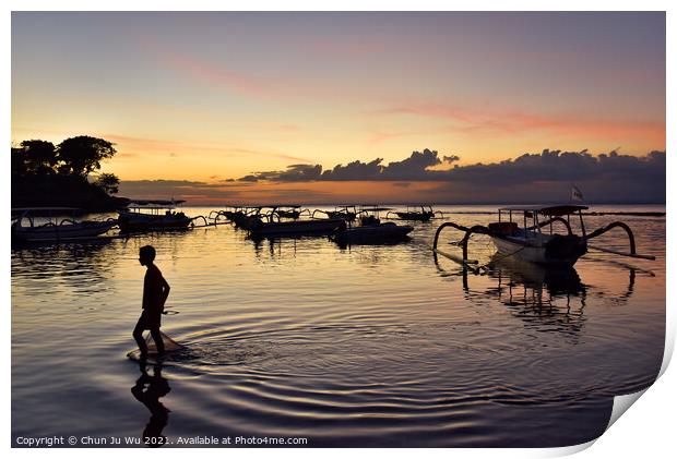 A boy walking through the sea water with sunset at background in Bali, Indonesia Print by Chun Ju Wu