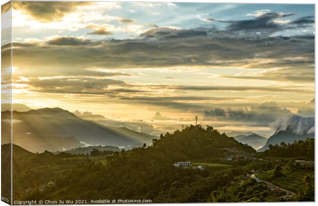 Mountains under the light of sunrise through clouds Canvas Print by Chun Ju Wu