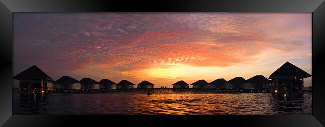 Maldives sunset over water bungelows Framed Print by mark humpage
