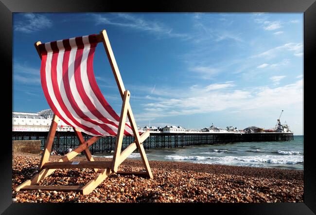 Striped Deckchair on Brighton Beach, England Framed Print by Neil Overy
