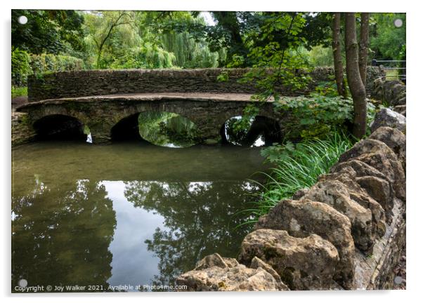 A pedestrian bridge over the river in Castle Combe, Wiltshire, UK Acrylic by Joy Walker