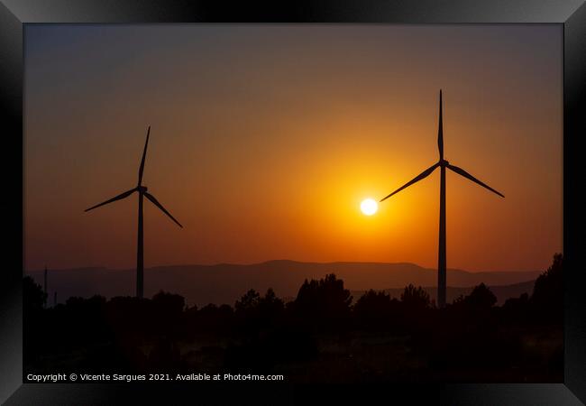 Two windmills facing the sun at sunset Framed Print by Vicente Sargues