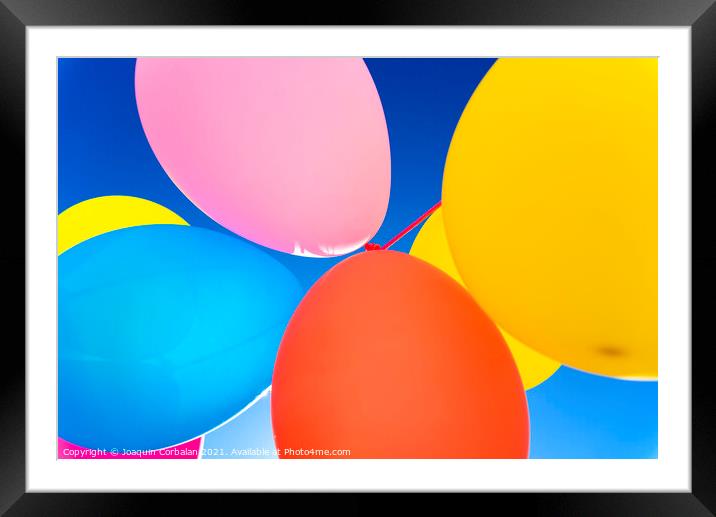 Colorful balloons inflated against the sun, festive and joyful colorful background. Framed Mounted Print by Joaquin Corbalan