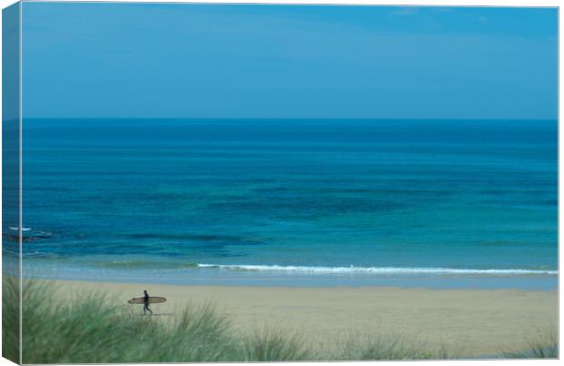 A lone surfer leaving the beach at Constantine Bay, Cornwall Canvas Print by Frank Farrell