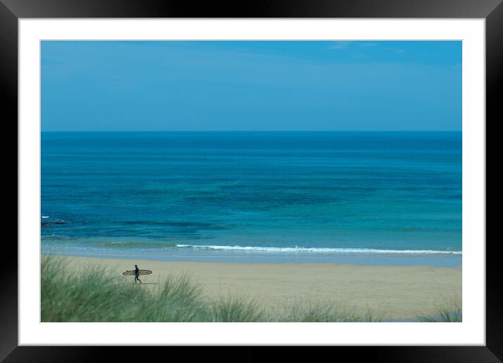 A lone surfer leaving the beach at Constantine Bay, Cornwall Framed Mounted Print by Frank Farrell