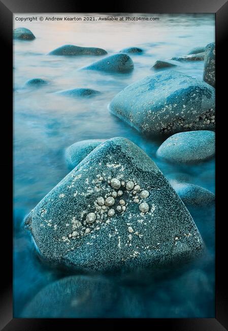 Rising tide around rocks at dusk Framed Print by Andrew Kearton