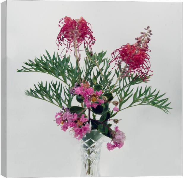 Grevillea and Lantana blooms in a vase. Canvas Print by Geoff Childs