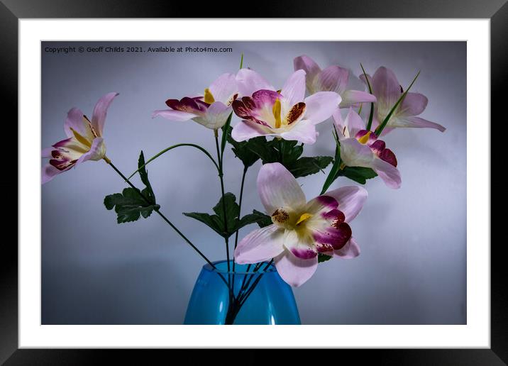 A Pretty display of pink and red artificial flowers. Framed Mounted Print by Geoff Childs
