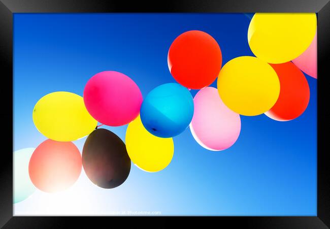 Colorful balloons inflated against the sun, festive and joyful c Framed Print by Joaquin Corbalan